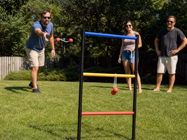 Friends tossing bolas toward a three-rung ladder target on grass.