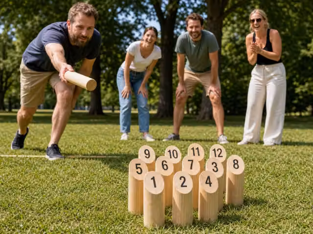 A player tossing a wooden baton toward numbered wooden skittles on grass.