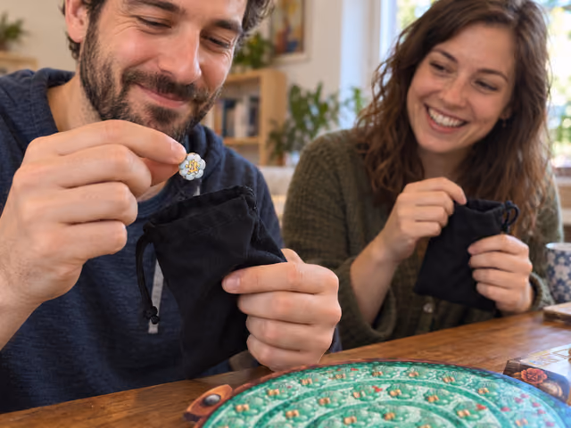 Two adults draw ingredients from black cloth bags while playing the classic Quacks of Quedlinburg game.